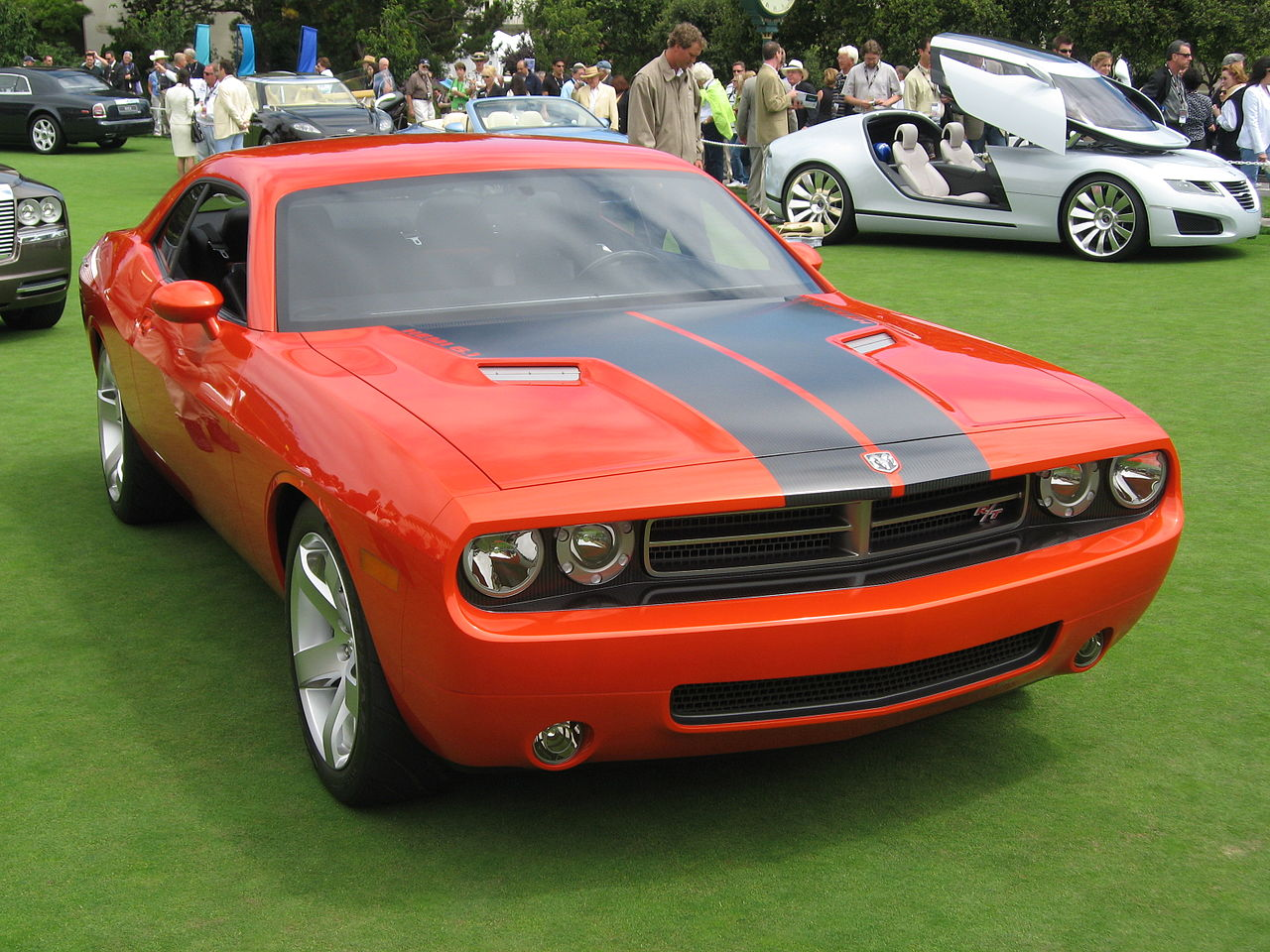 Modern 2008 Dodge Challenger with its retro styling, tying it back to the look of the first generation with big wheels, small side windows, and an aggressive stance. Sitting on grass. 