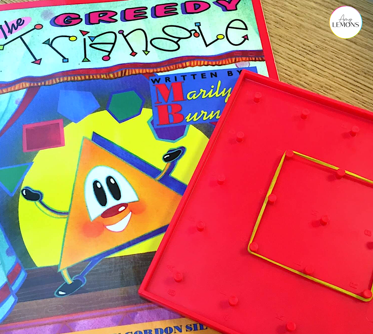 The Greedy Triangle book and a geoboard with a rubberband shape.