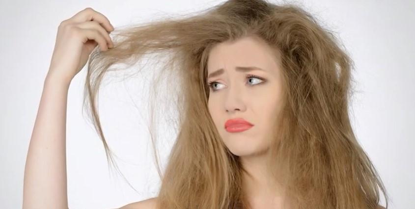 upset girl holding dry hair 