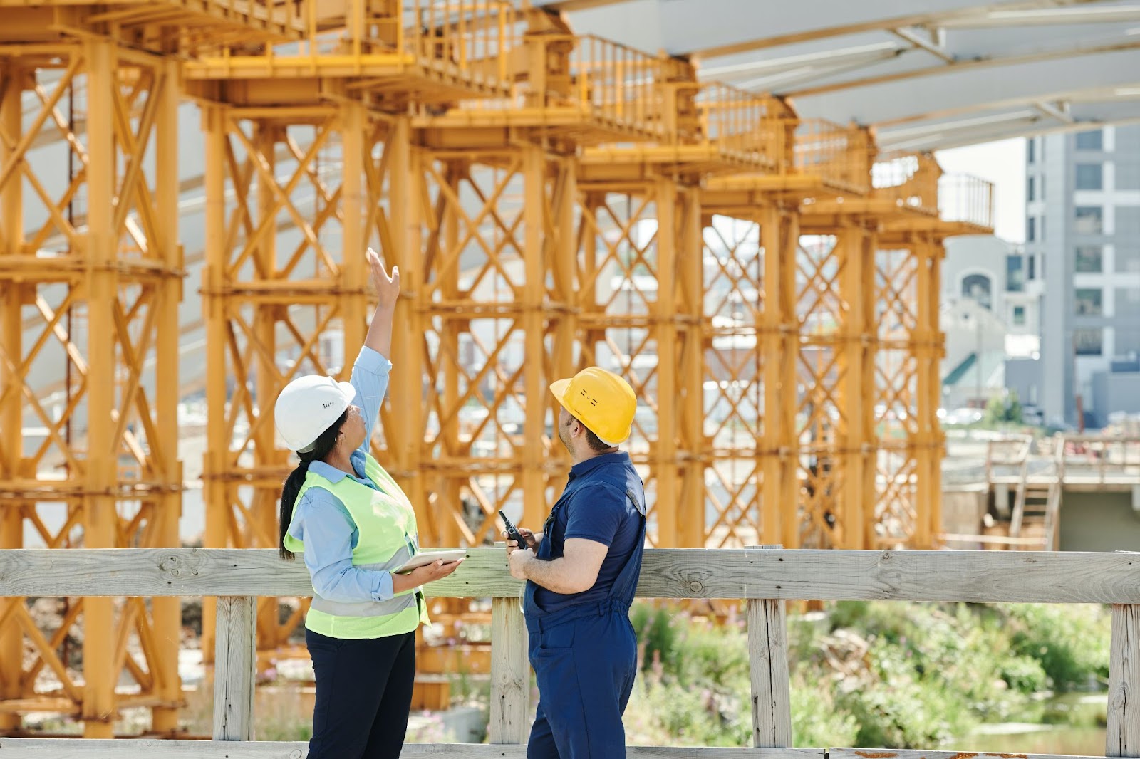 A man and a woman talking at a construction site.