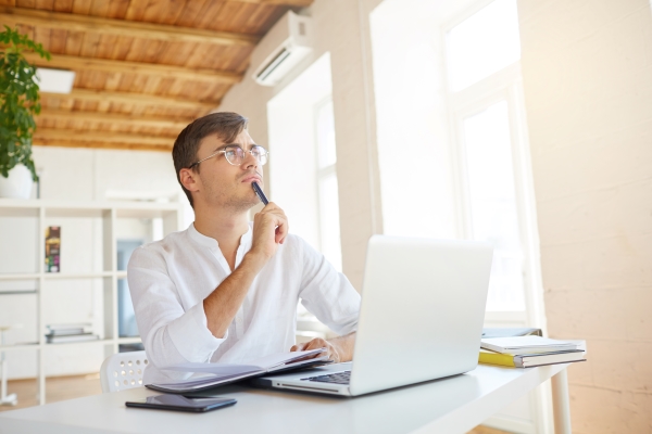 man-thinking-while-sitting-with-laptop