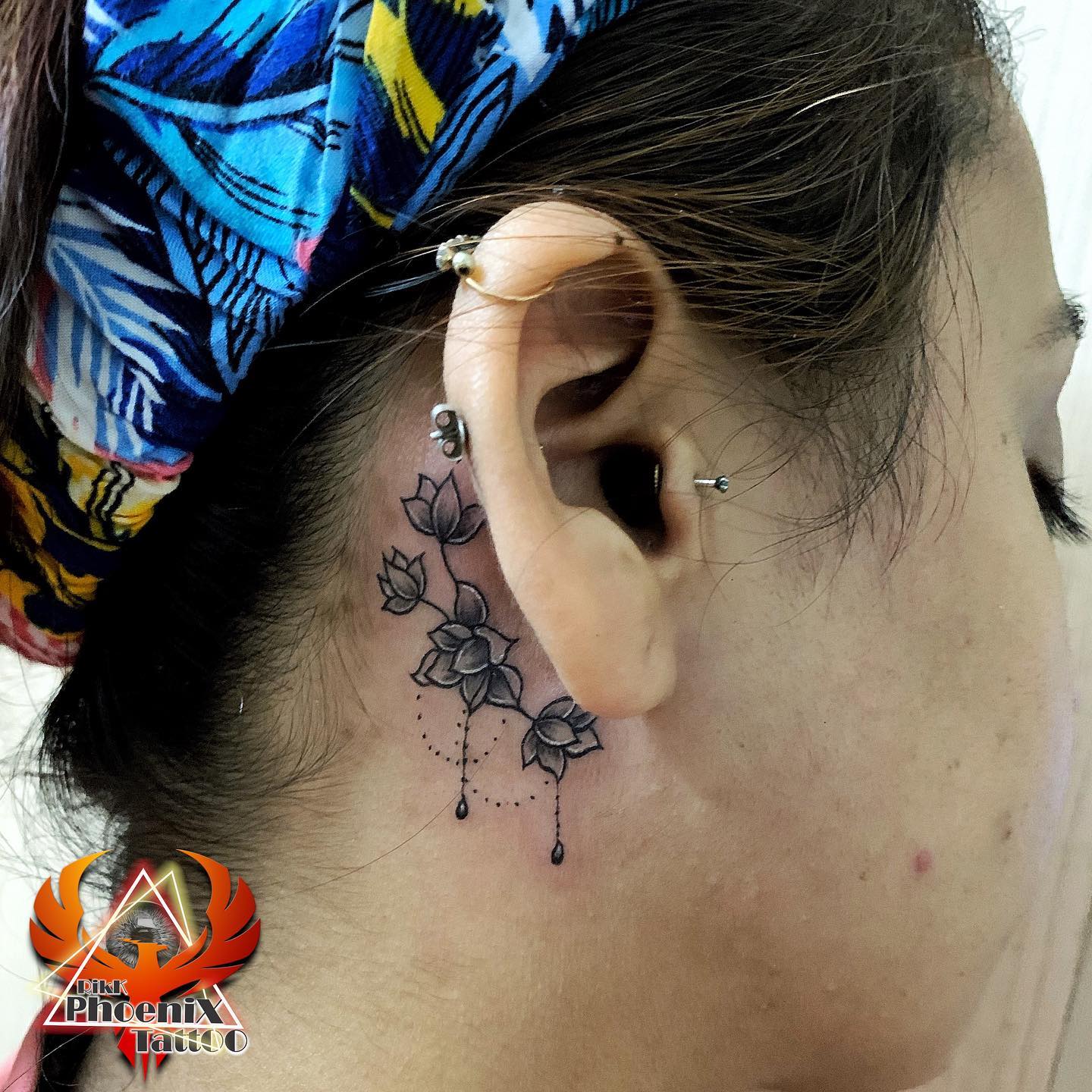 Black Flowers Behind The Ear Tattoo