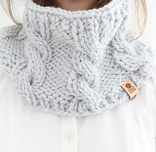 close up of woman wearing gray cable knit chunky cowl
