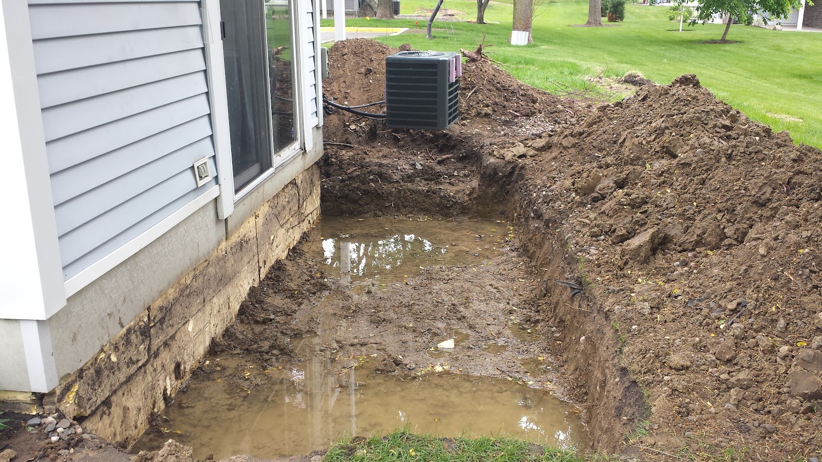 Clay soils holding water around this foundation. Notice some cracking on the foundation wall. 