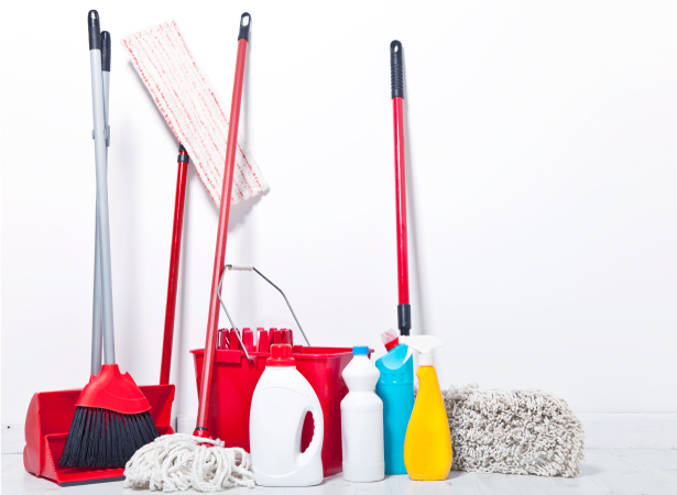 Cleaning supplies, including a broom and dustpan, mop and bucket, microfiber duster, and cleaning products