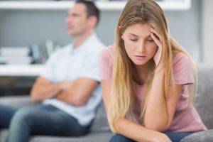 Couple not talking after a fight about signs your partner is depressed on the sofa in living room at home