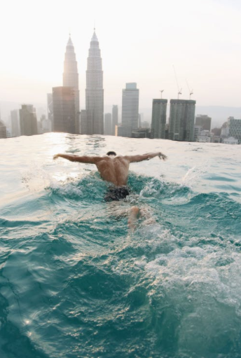 Person swimming in infinity edge pool