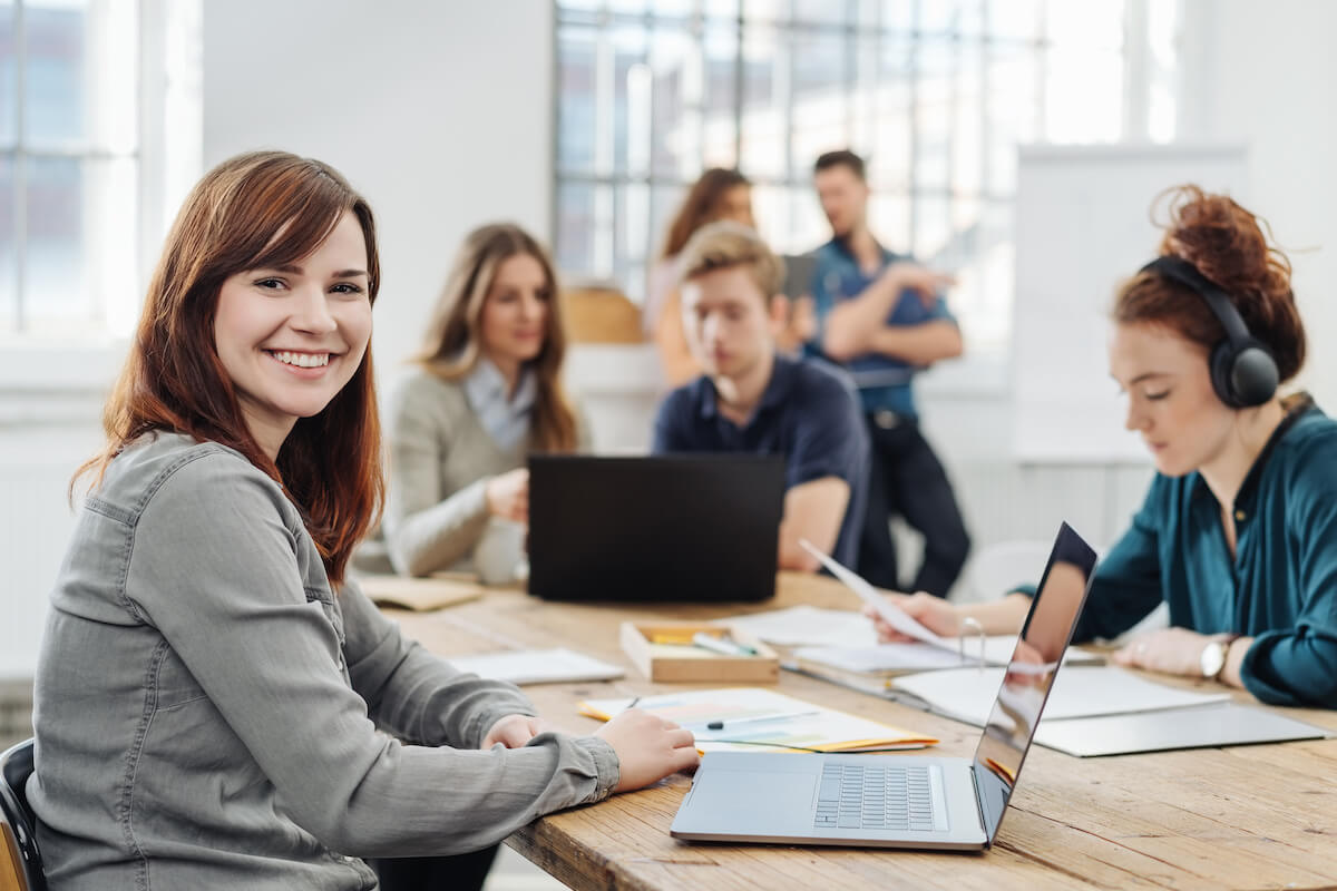 EHR training: employee happily looking at the camera while working