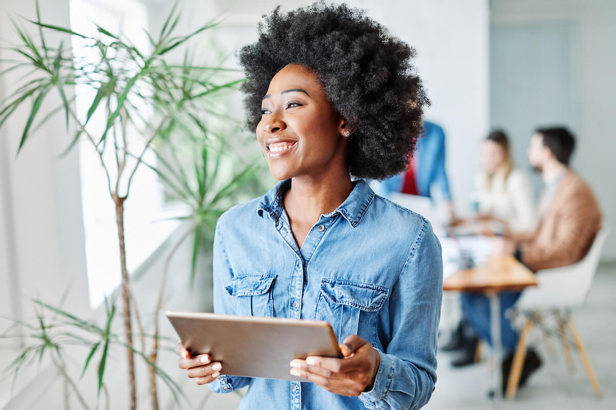 Employee happily carrying a tablet