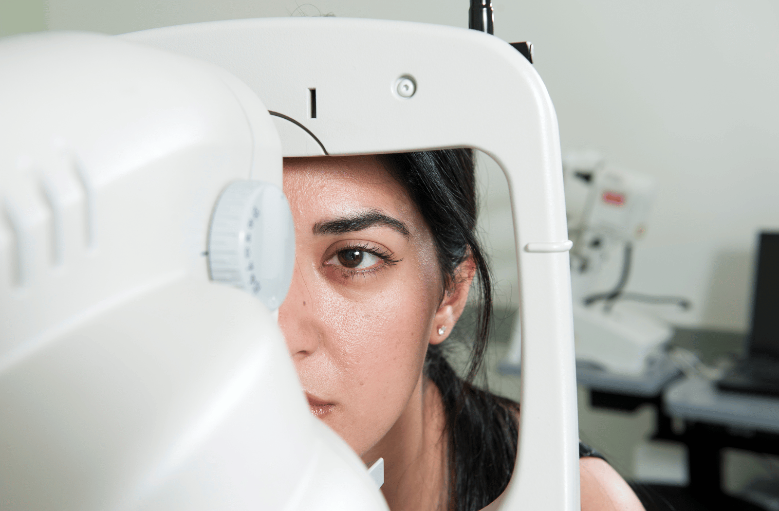 A woman receiving a comprehensive eye exam from her optometrist