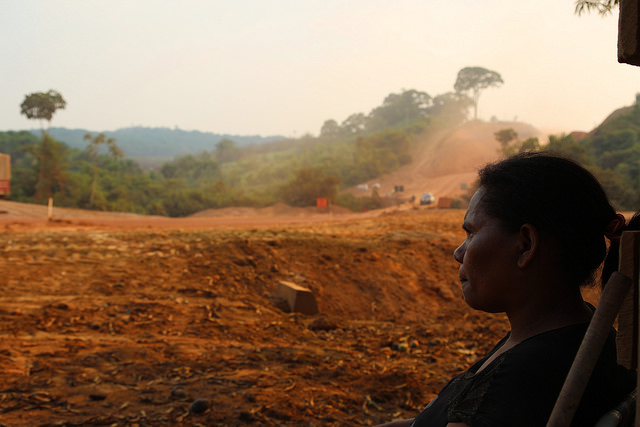 Una campesina observa la reconstrucción de una carretera amazónica en el estado de Pará, en el norte de Brasil. Larguísimas carreteras de sur a norte y de este a oeste fueron construidas durante la dictadura militar con el objetivo estratégico de integrar la ecorregión al resto del país, pero quedaron inconclusas o abandonadas y buena parte intransitables durante la estación de lluvias, hasta que se convirtieron en indispensables para la expansión agrícola. Crédito: Fabiana Frayssinet/IPS