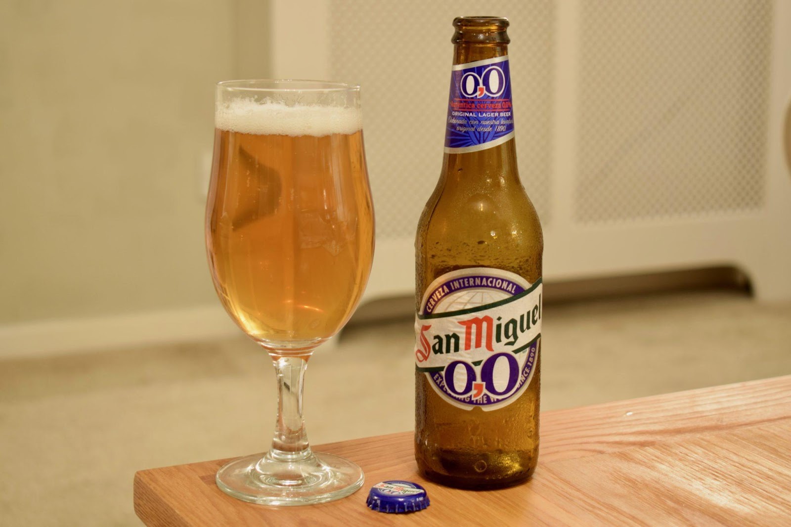 San Miguel 0% Alcohol Beer and glass on a wooden table