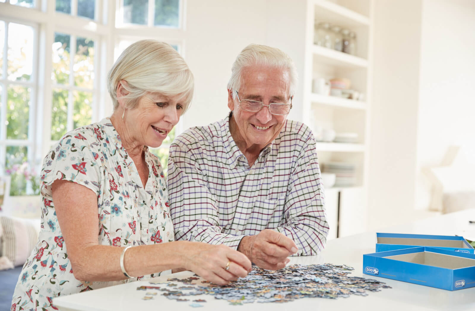 two seniors do a puzzle together as a memory recall exercise