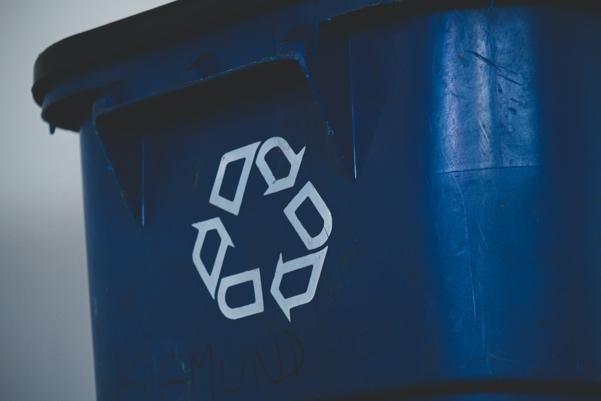 Trash cans with a recycling sign.