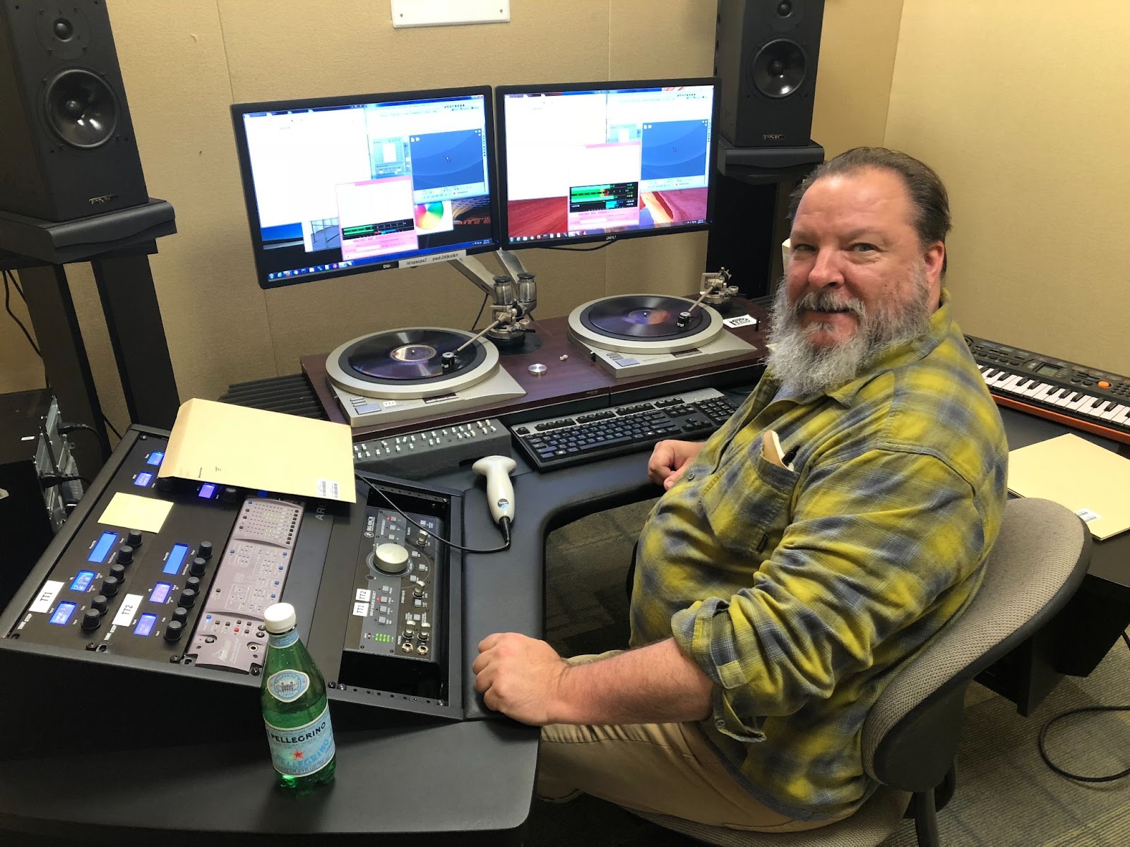Eric Ederer sitting at desk with specialized sound equipment