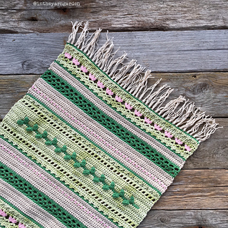 green and pink table runner on wooden background