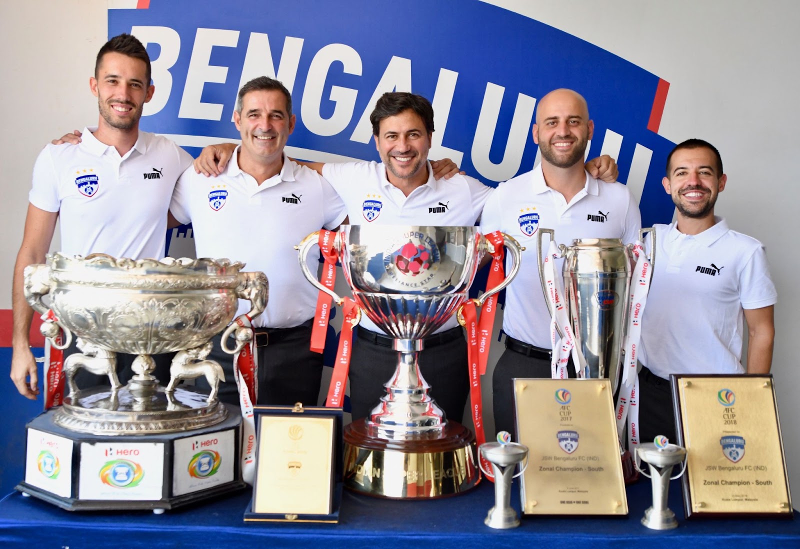 Carles Cuadrat and his coaching staff with their titles at Bengaluru