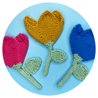 three flat knitted tulips on blue background
