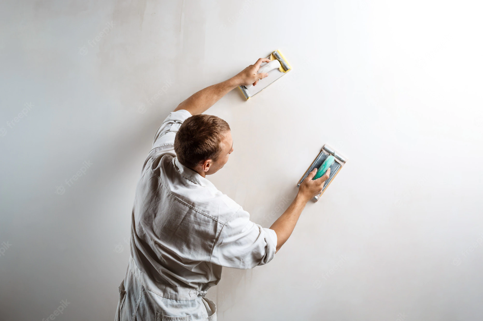 Guy painting wall