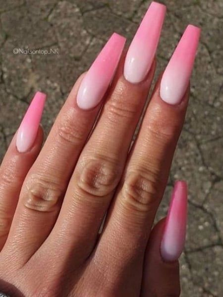Picture of a lady's hand rocking the pink ombre nail look
