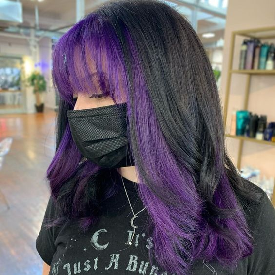 lady wearing her long hair with purple bangs
