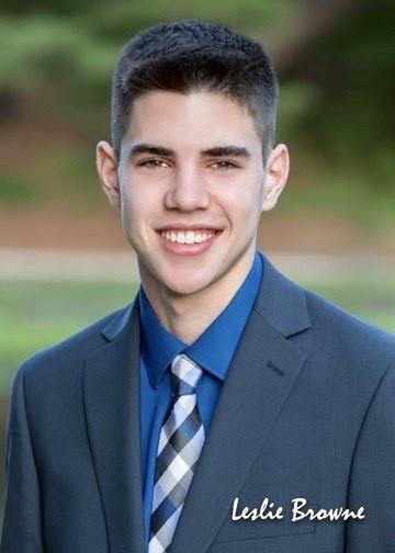 A person wearing a suit and tie smiling at the camera

Description automatically generated