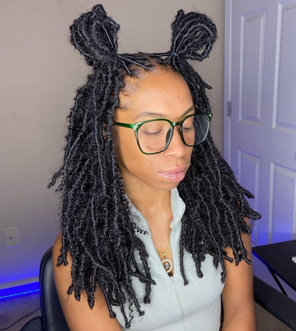 Lady shows off her hairdo wrapped in two space buns