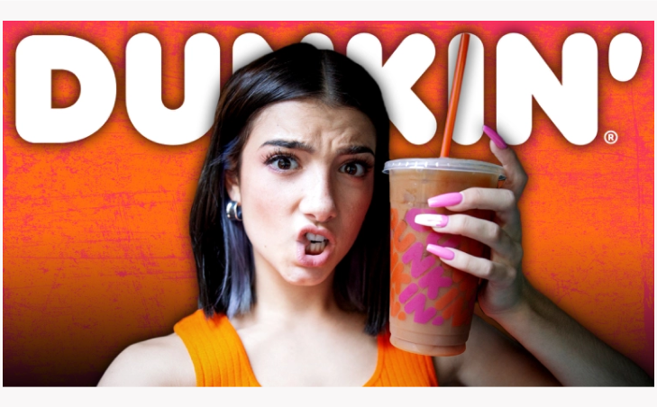 An image showing TikTok star Charli D’Amelio holding a Dunkin' iced coffee.