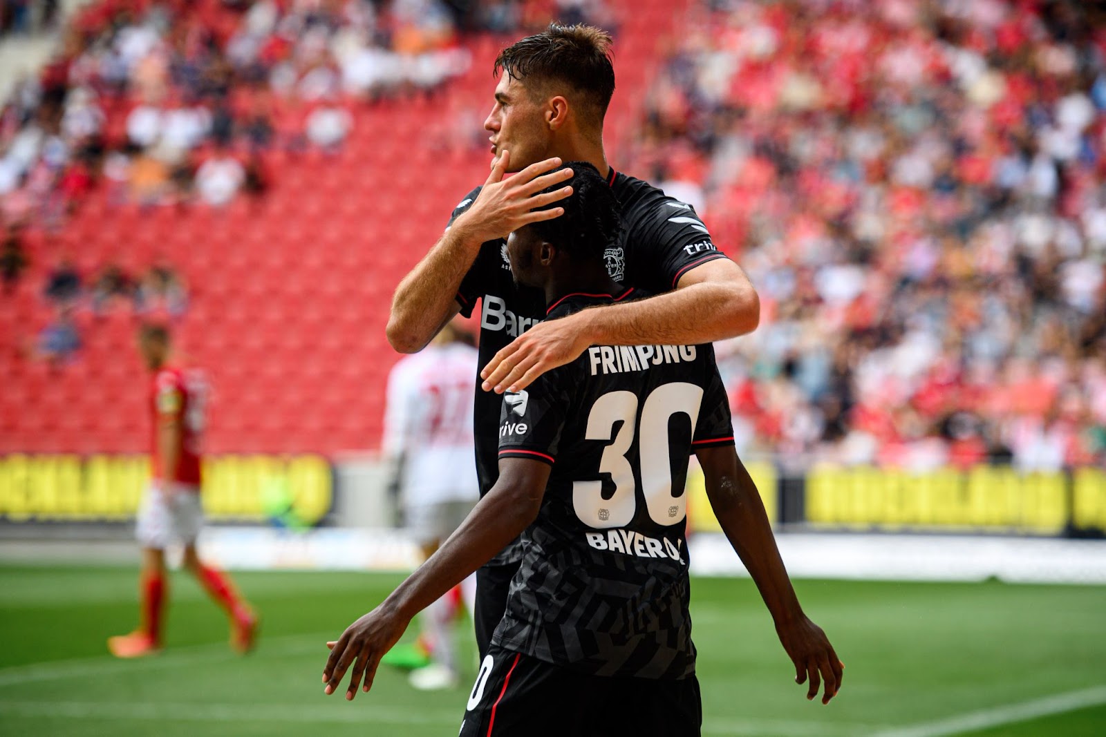 Bayer Leverkusen players celebrate after scoring a goal against Mainz