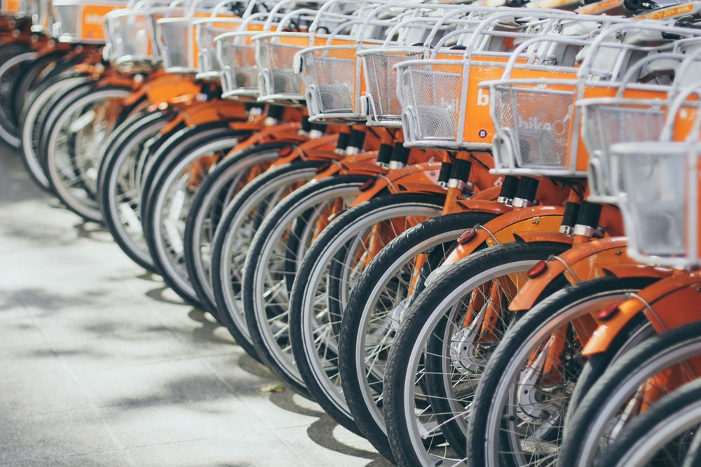 A long row of orange rental bicycles in Santiago
