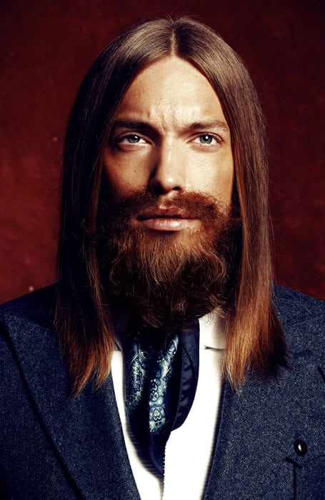 Full picture showing a guy with a straight hair sectioned into the middle part