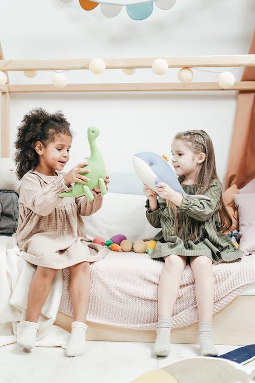 Free Photo of Two Girls Playing With Stuffed Animals Stock Photo