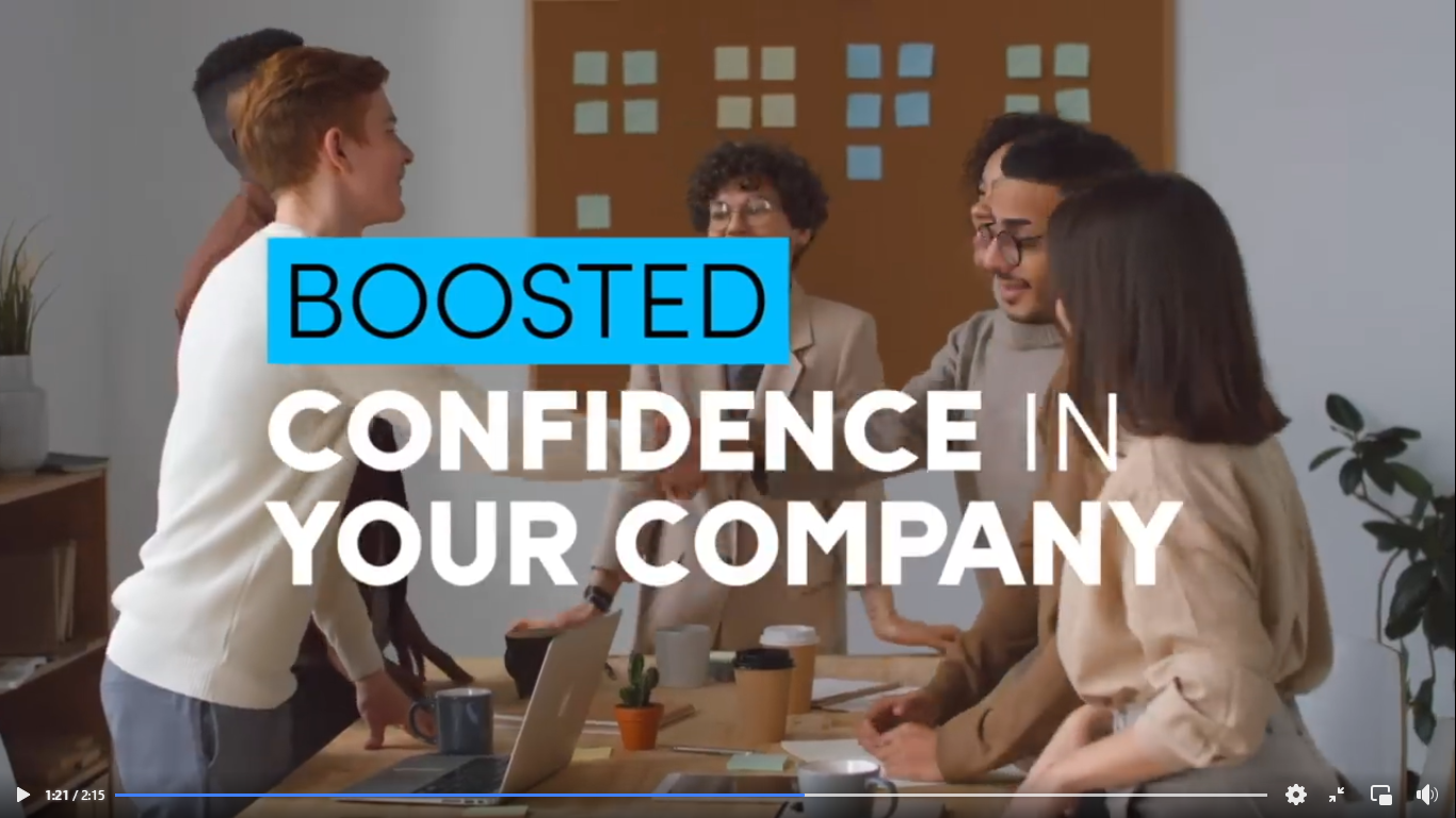 A group of people standing around a table with a sign  Description automatically generated with low confidence