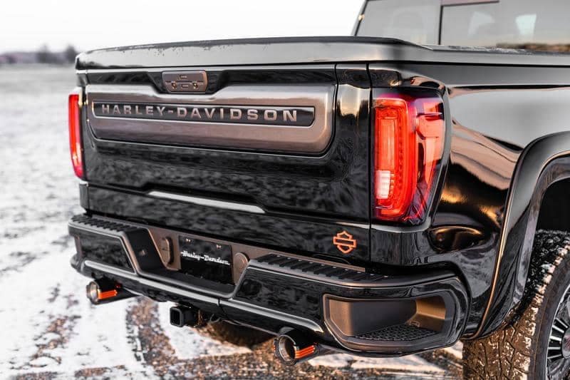Rear view of a powerful 2020 Harley Davidson truck parked on a snowy rocky trail, highlighting its robust design and rugged capabilities