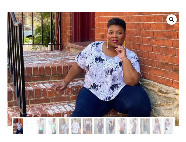 Fat black woman in white and blue shirt and blue pants sitting on brick steps.