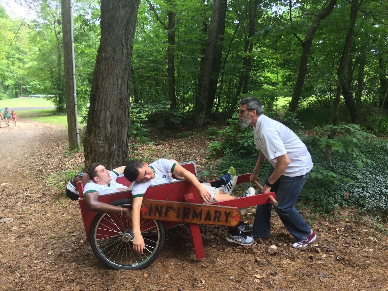 A man playing with young children at summer camp