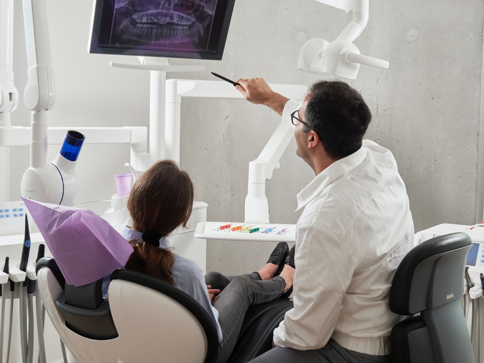 Dentist looking at an xray with his patient