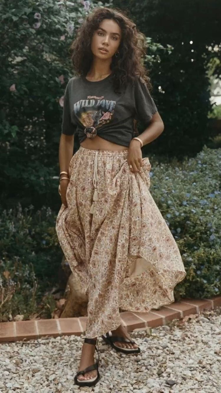 Woman wearing black t-shirt over bohemian skirt