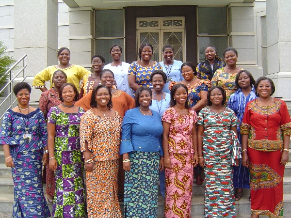 Black Mormon women standing outside a temple.