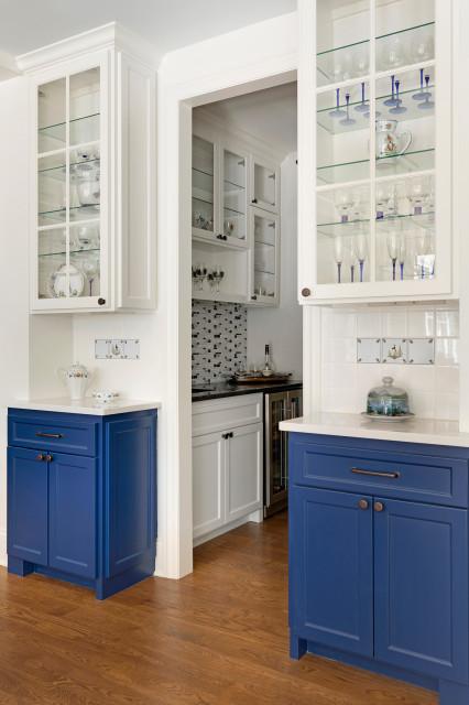 A buffet holds displays glassware and featured Quimper tiles. 