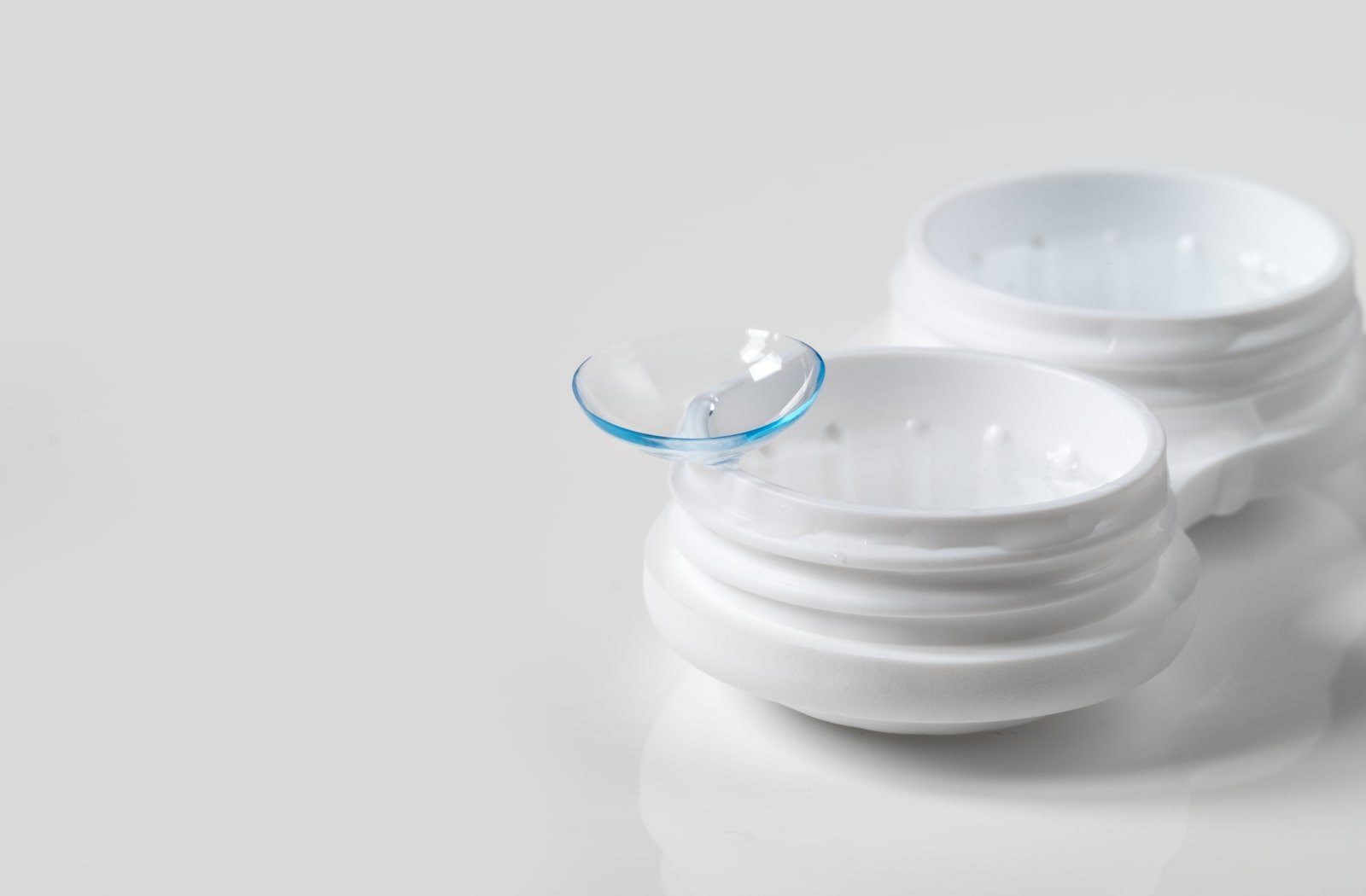A contact lens sitting on a contact lens case