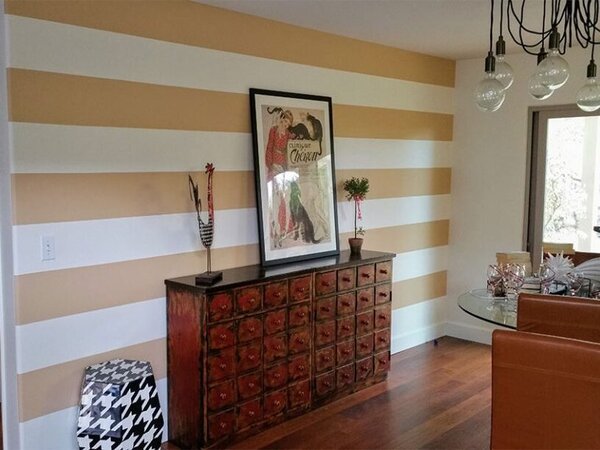 Room with dark beige and white striped wall