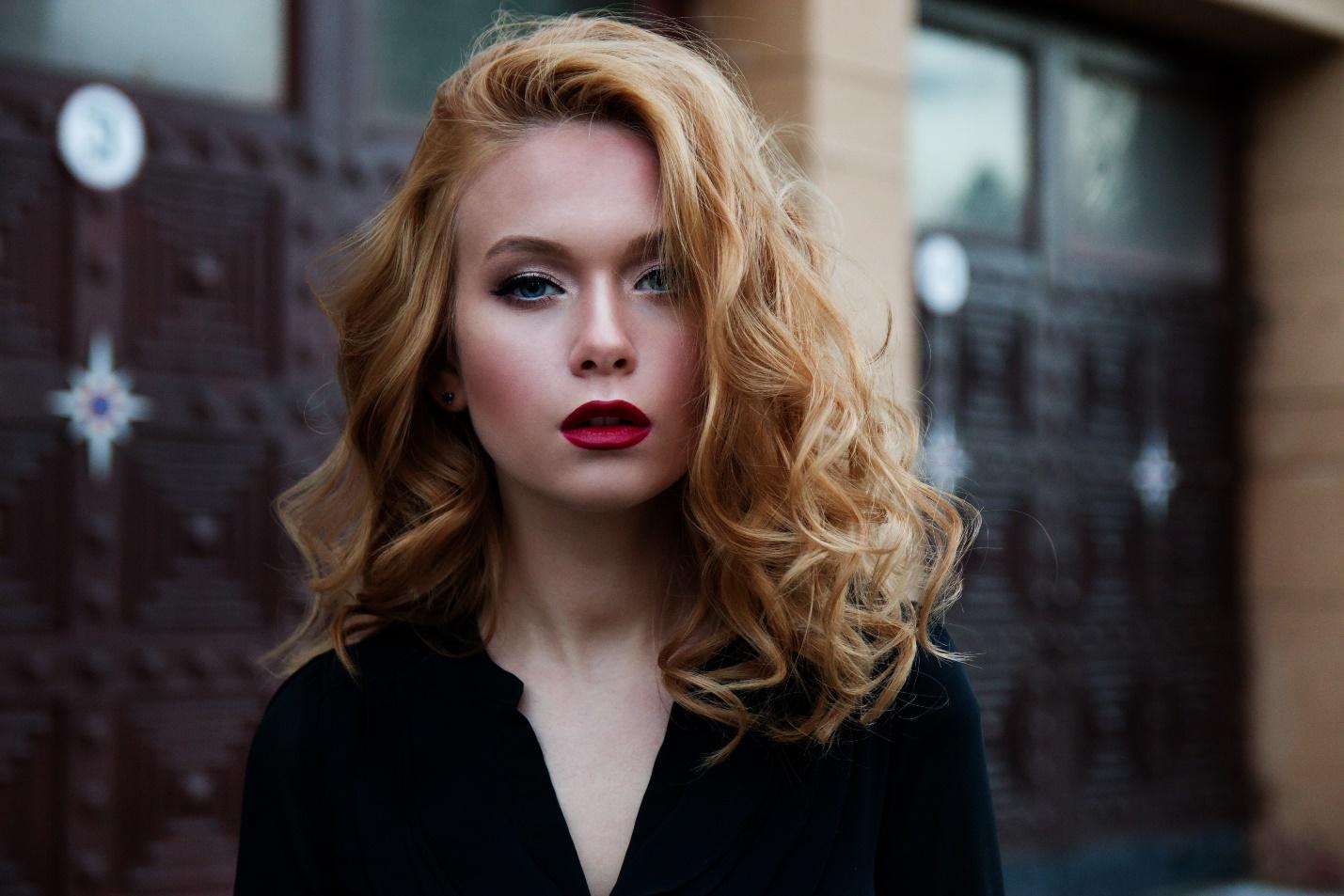 una ragazza bionda che indossa un rossetto rosso