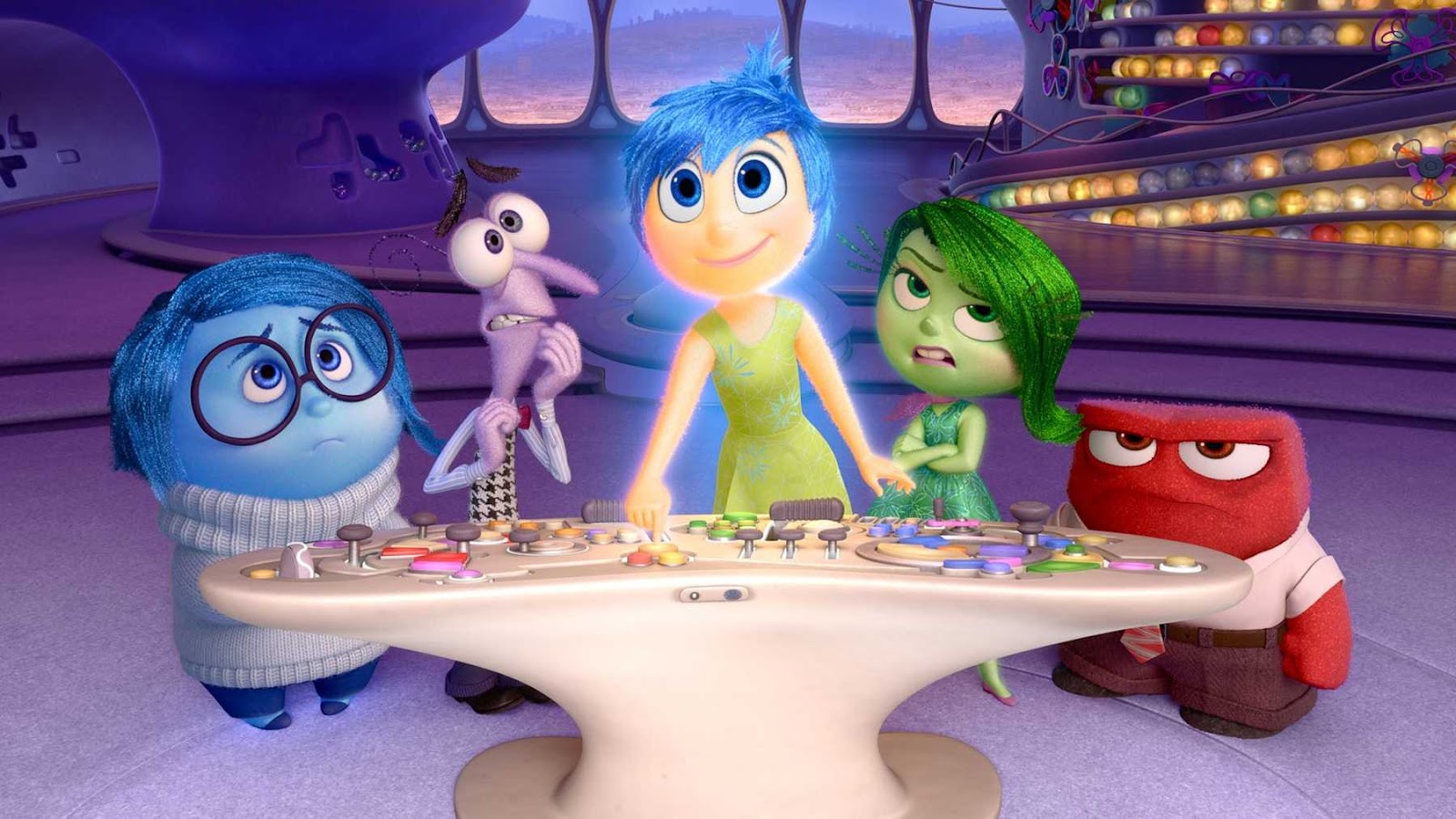 A screen still from Inside Out, featuring the emotions standing behind their control board. Behind them are glowing orbs.
