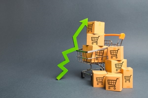 Shopping cart with cardboard boxes with a pattern of trading carts and a green up arrow