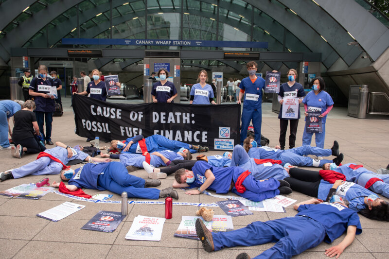 Doctors lying on the floor in front of Canary Wharf station