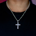 A Silver Cross With Diamond Accents