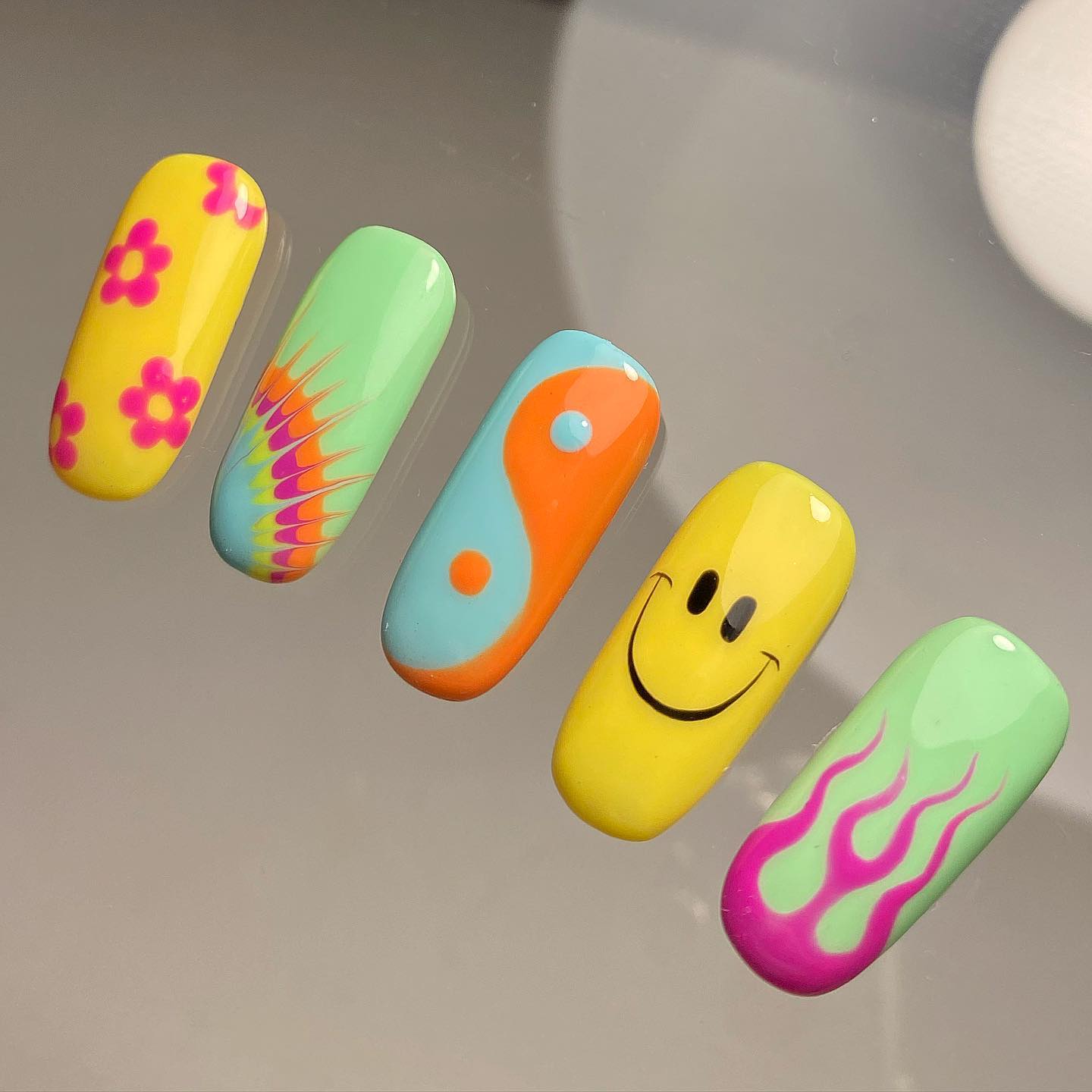 Mix and match summer nail idea with smiley face and flower