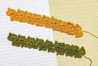 Two crochet bookmarks that look like bunched leaves