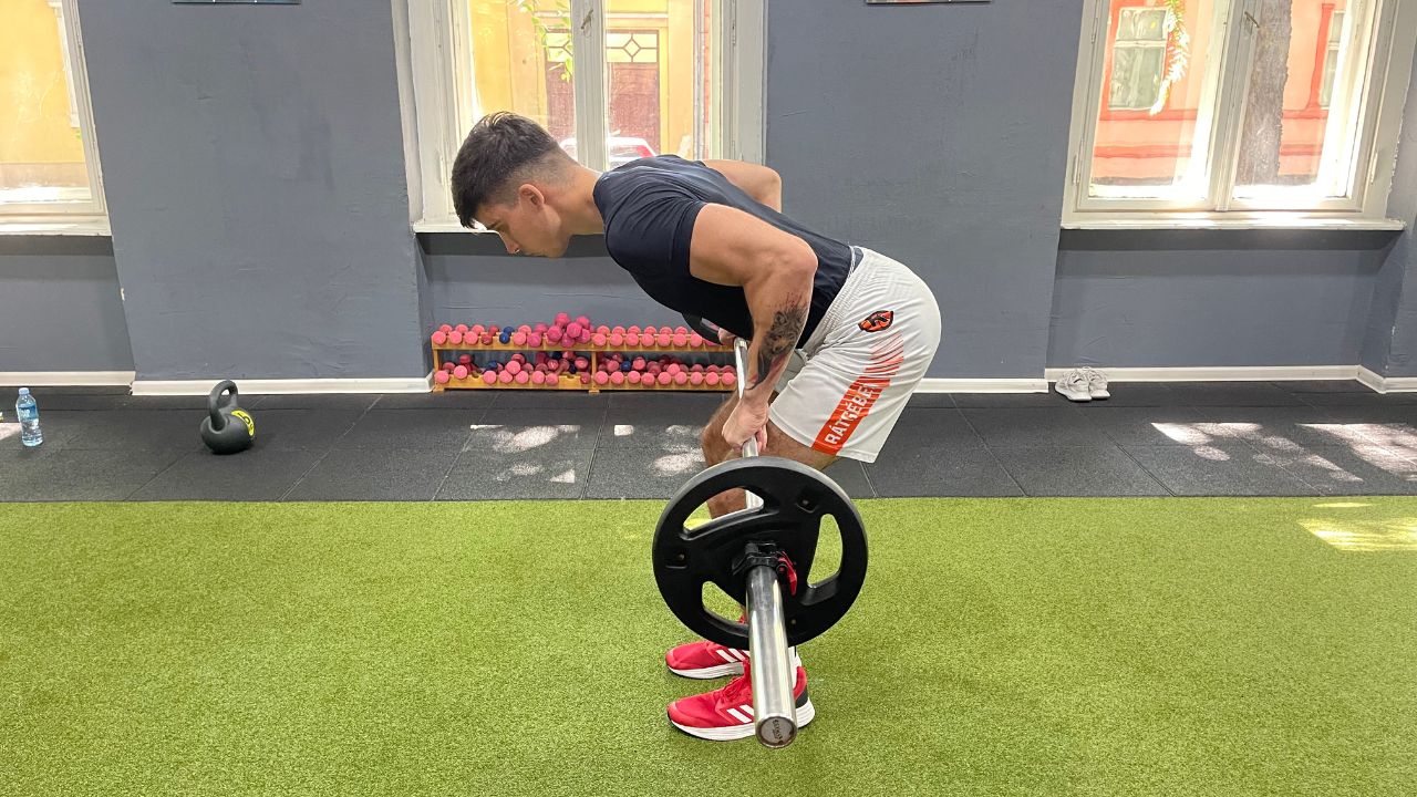 Vanja performs barbell bent-over rows.